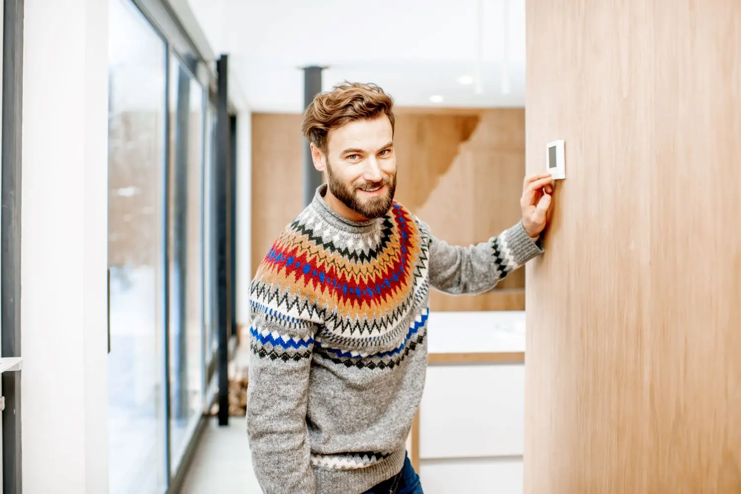 man-adjusting-temperature-with-thermostat-at-home-2025-03-14-03-37-38-utc